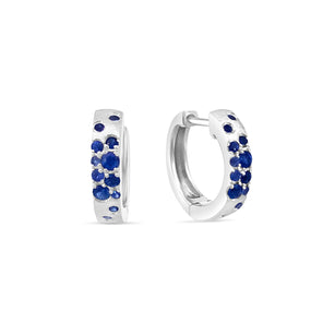white gold hoop earrings with blue gemstones on a white background