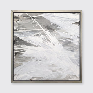 A grey, beige and white abstract print in a silver floater frame hangs on a white wall.